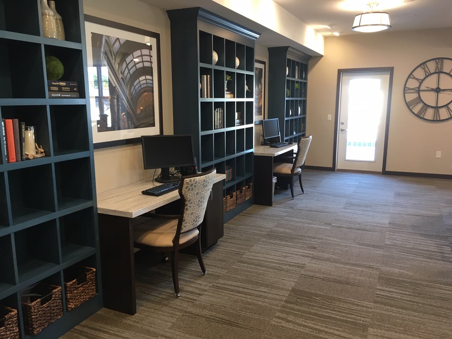 Cozy workspace in community library with blue shelves and computers.