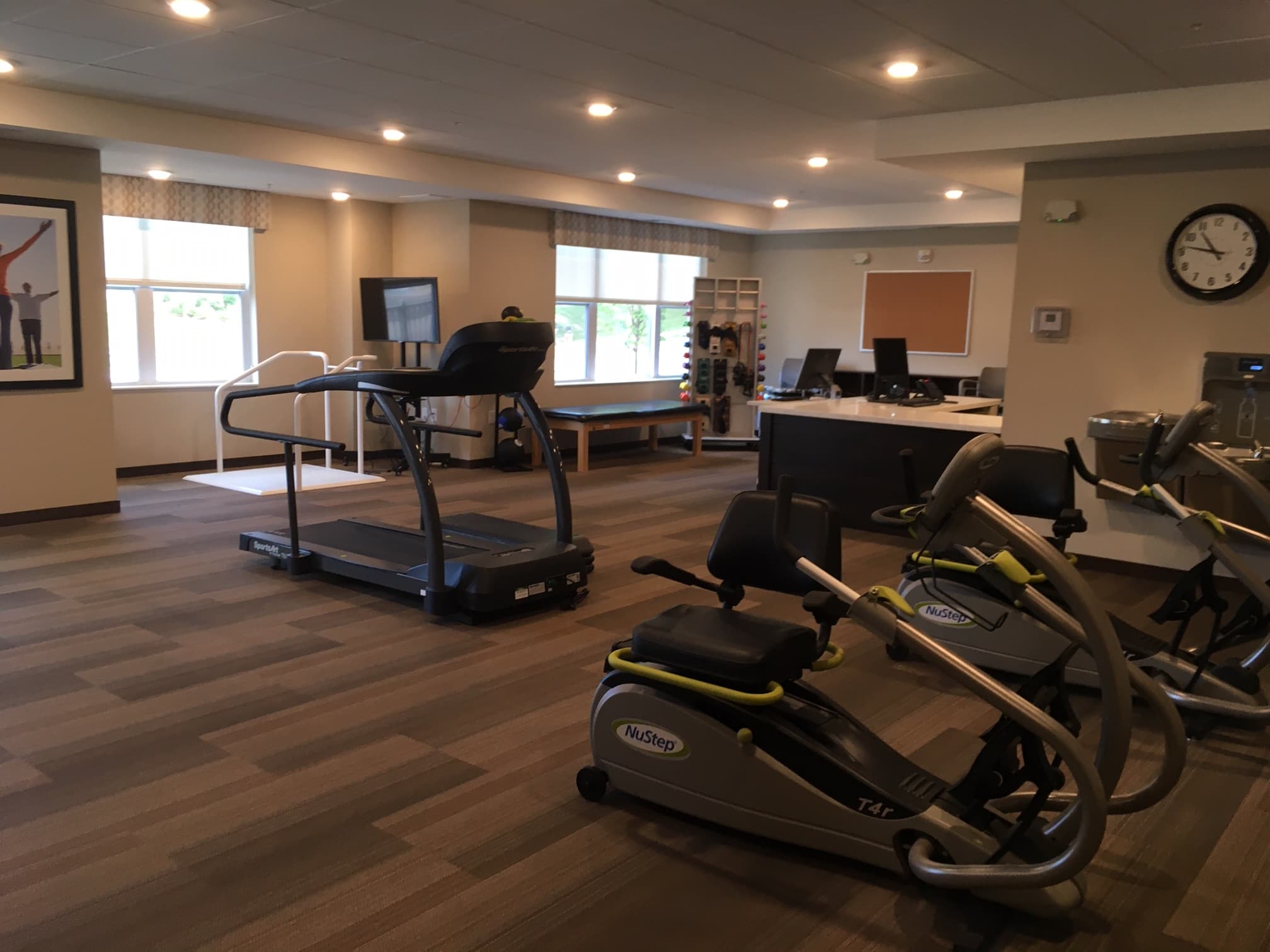 Exercise room with treadmills and fitness equipment in senior community.