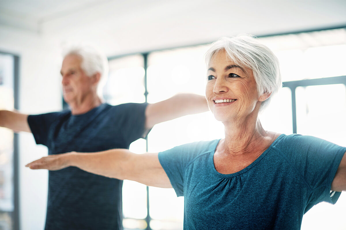Seniors stretching in senior living wellness center